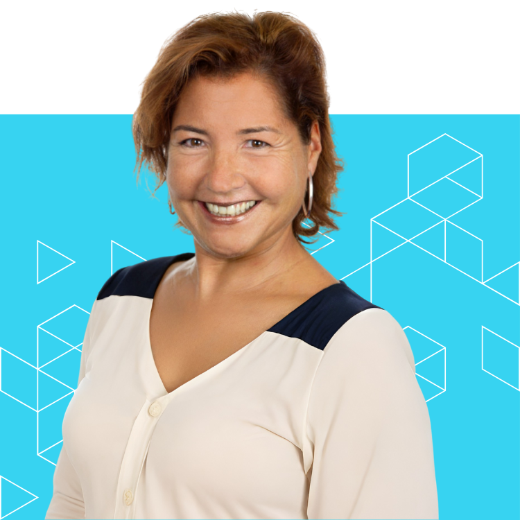 A woman with short brown hair is smiling, wearing a cream blouse with dark shoulder accents, standing in front of a blue background with geometric line patterns.