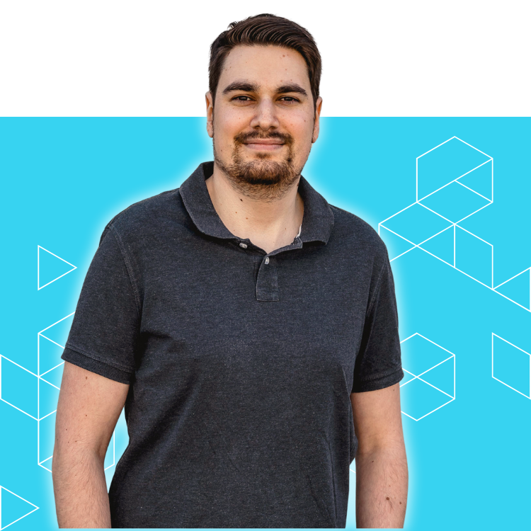A man with short dark hair and a beard wears a dark polo shirt, standing in front of a bright blue background with geometric line patterns and white outlined cubes.